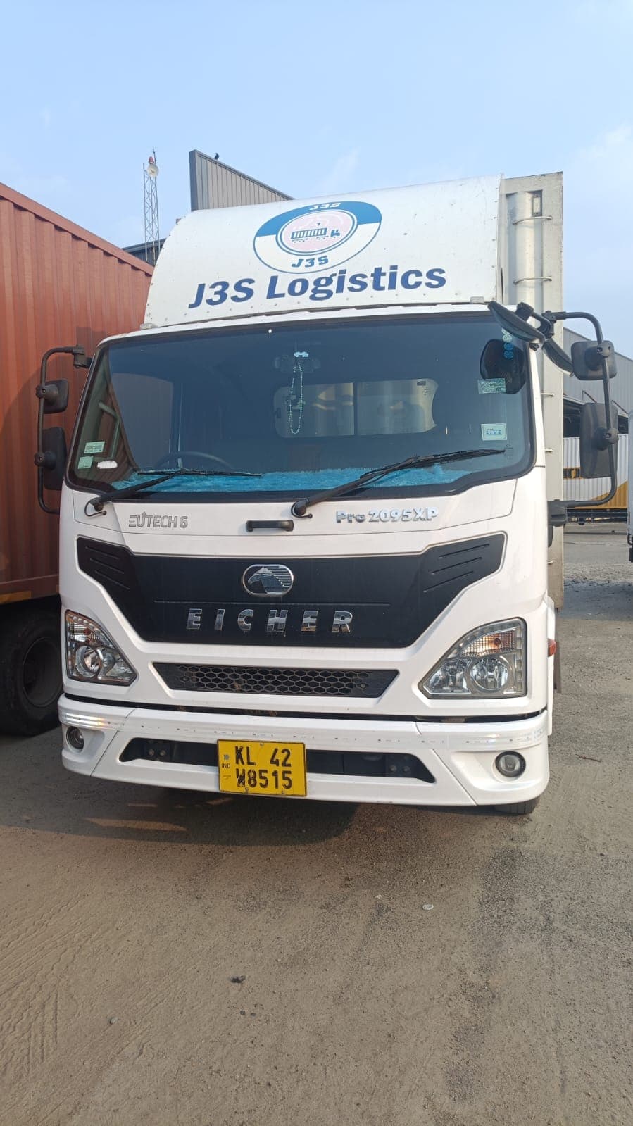 J3S Logistics truck beside containers